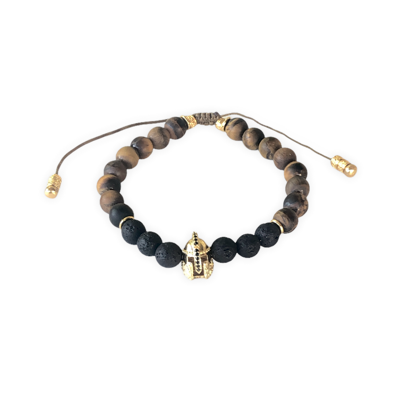 Espectacular pulsera de piedra natural lava y ojo de tigre, cuentas de zamak con baño de oro y un casco de Guerrero con baño de oro que hace que sea ideal para el día a día. Esta pulsera es ajustable lo que la hace perfecta. Frontal