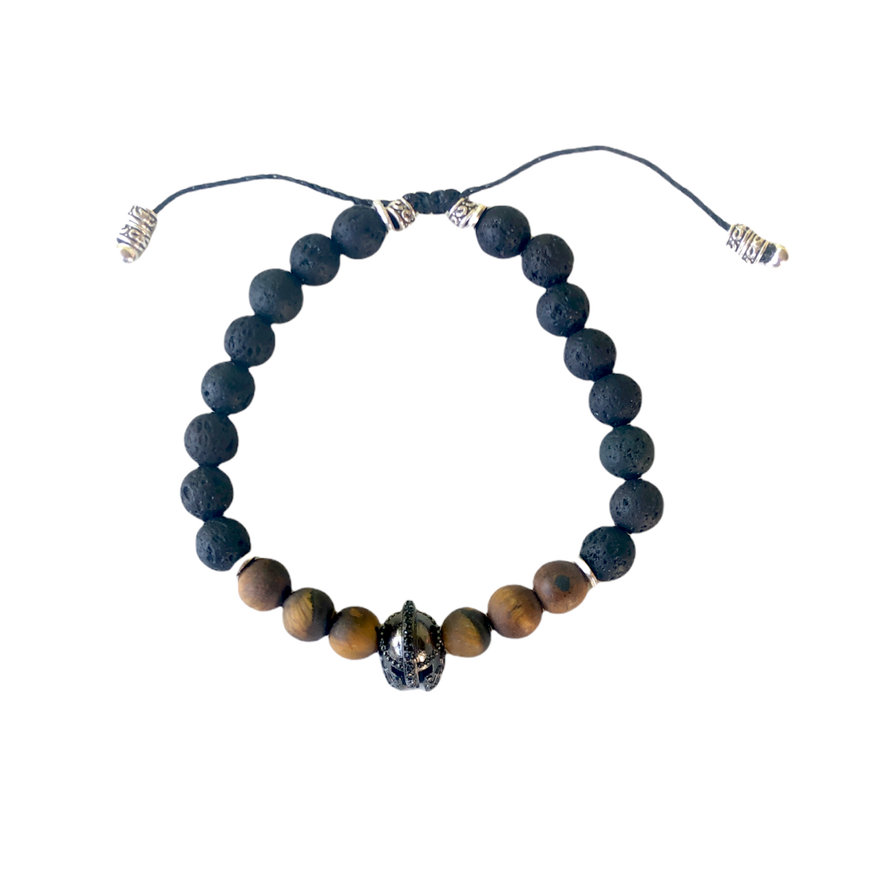 Espectacular pulsera de piedra natural lava y ojo de tigre, cuentas de zamak con baño de plata y un casco de Guerrero con baño de cromo negro que  hace que sea ideal para el día a día. Esta pulsera es ajustable lo que la hace perfecta. 